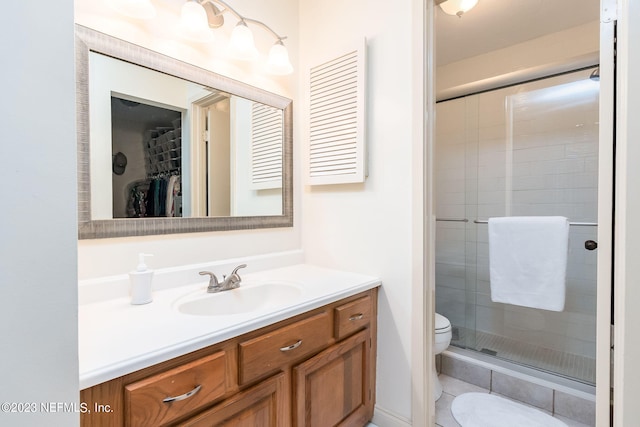 bathroom with tile patterned flooring, walk in shower, vanity, and toilet