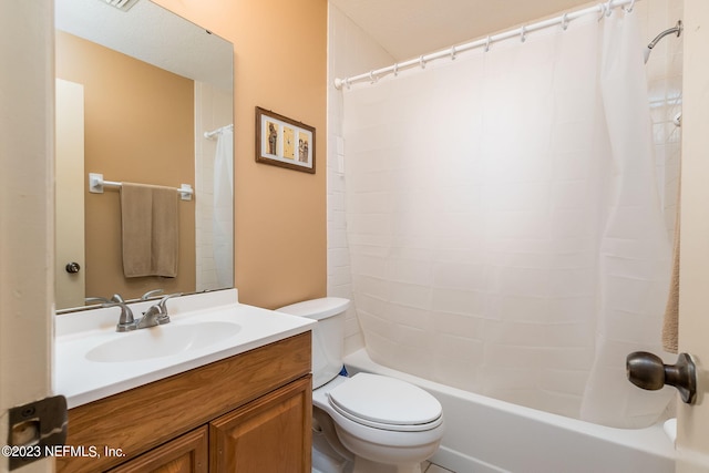 full bathroom featuring shower / bath combo, vanity, and toilet