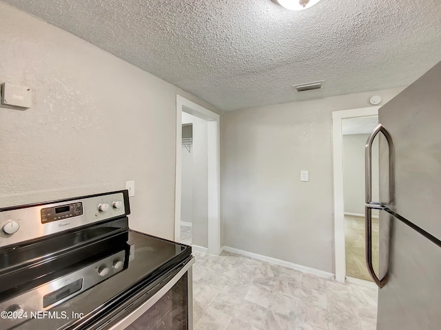 kitchen featuring appliances with stainless steel finishes and a textured ceiling