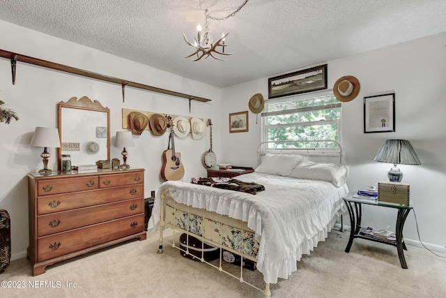 bedroom featuring a chandelier, carpet floors, and a textured ceiling