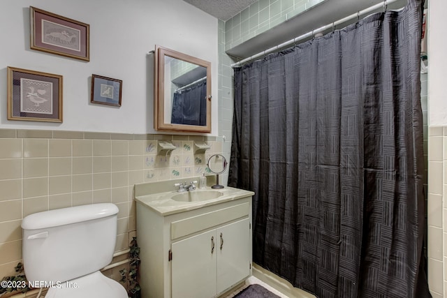 bathroom featuring vanity, toilet, tile walls, and a shower with curtain