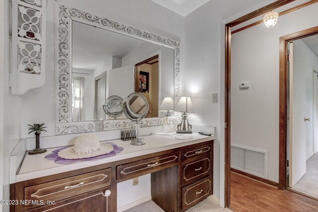 bathroom with vanity and hardwood / wood-style floors