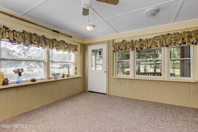 unfurnished sunroom with ceiling fan