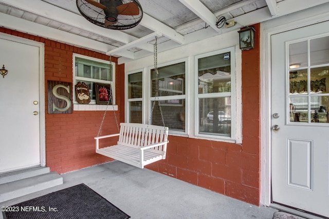 entrance to property featuring ceiling fan and covered porch