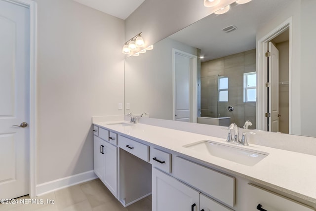 bathroom featuring tile patterned floors, vanity, and a shower with shower door