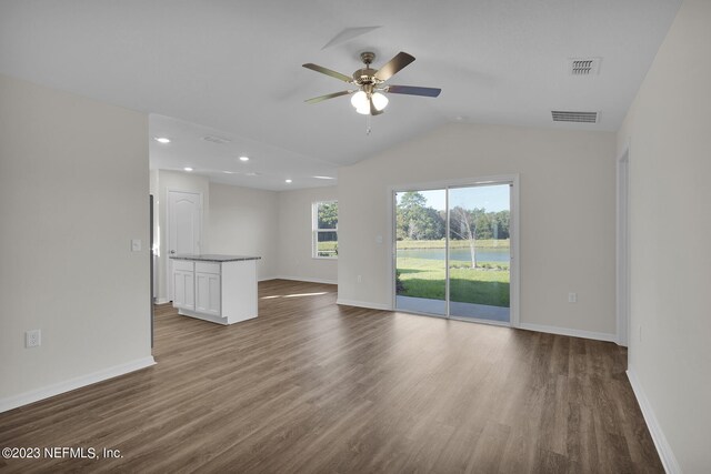 unfurnished living room featuring lofted ceiling, ceiling fan, and hardwood / wood-style flooring