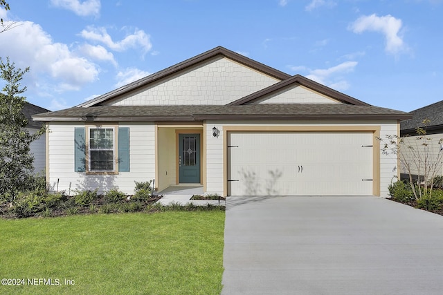 view of front of house featuring a front lawn and a garage