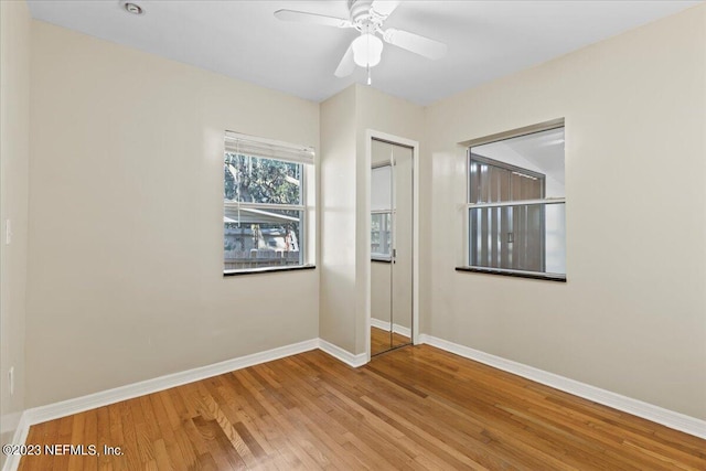 spare room with wood-type flooring and ceiling fan