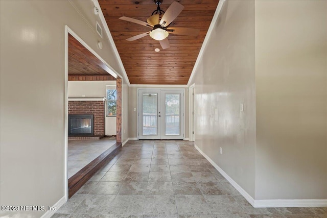 doorway with wood ceiling, lofted ceiling, a fireplace, ceiling fan, and french doors