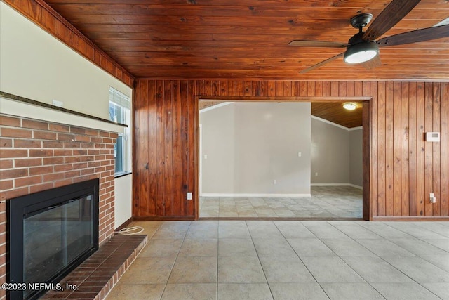 182 Cargo Way, Keystone Heights, FL 32656 - unfurnished living room with wood ceiling, wooden walls, baseboards, a ceiling fan, and a fireplace