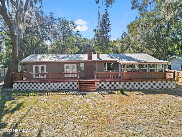 back of house with a yard and a wooden deck