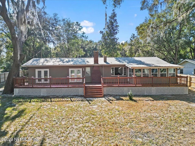 182 Cargo Way, Keystone Heights, FL 32656 - rear view of property with french doors, a wooden deck, metal roof, and a yard