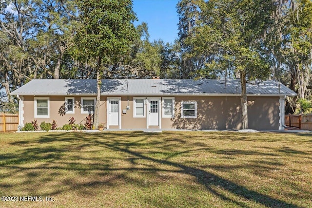 ranch-style house with a front lawn