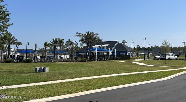 view of playground with a lawn