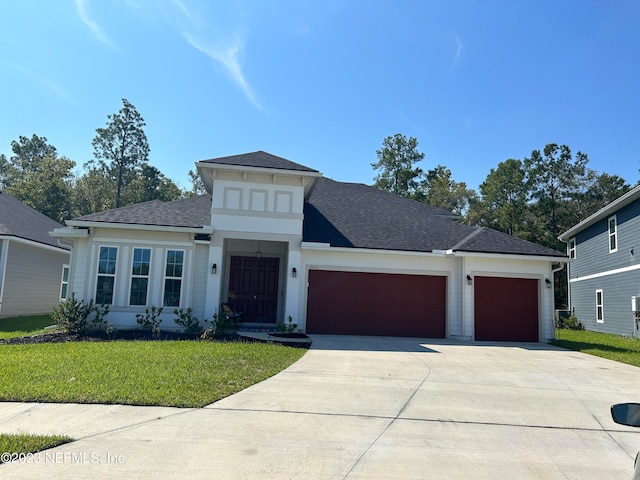 view of front facade with a garage and a front yard