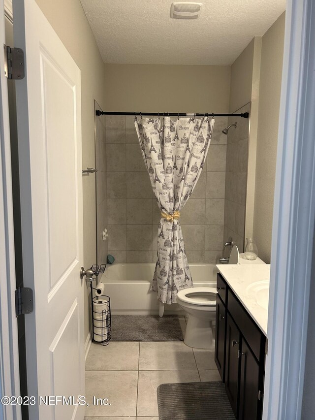 full bathroom with shower / bath combination with curtain, a textured ceiling, tile patterned floors, toilet, and vanity