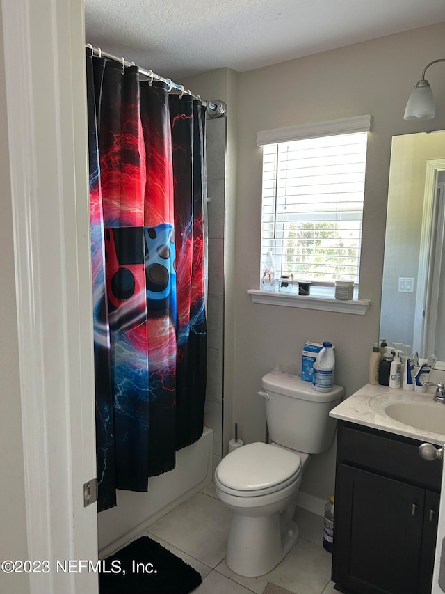 full bathroom with tile patterned flooring, shower / bath combo, a textured ceiling, toilet, and vanity