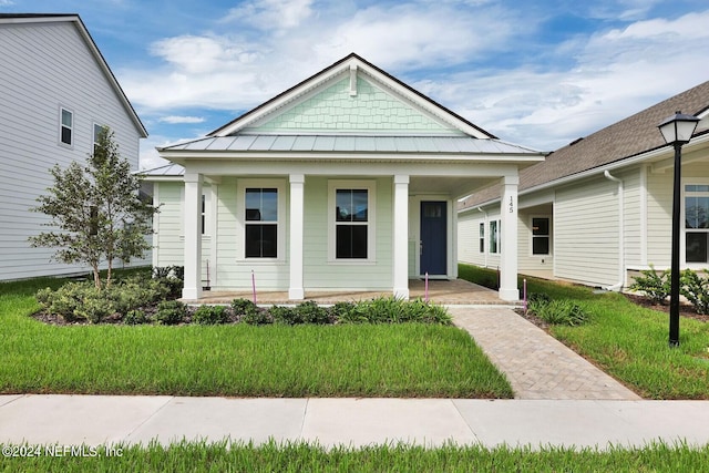 bungalow-style home with a porch and a front yard