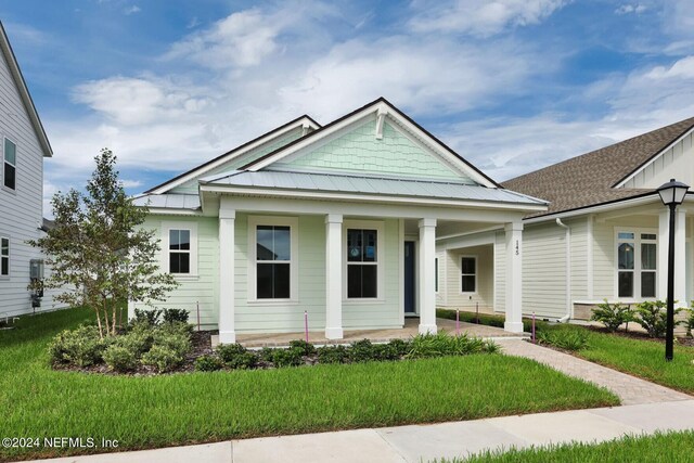 bungalow-style home featuring a porch and a front lawn