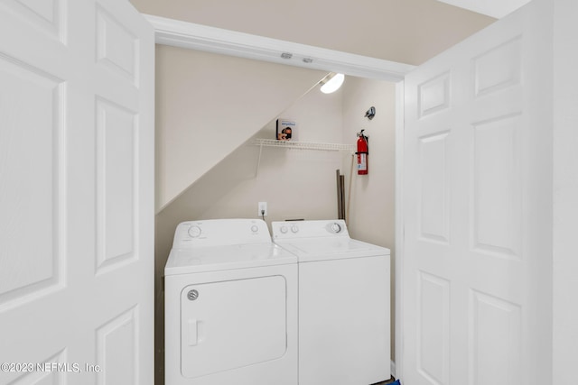 clothes washing area featuring independent washer and dryer