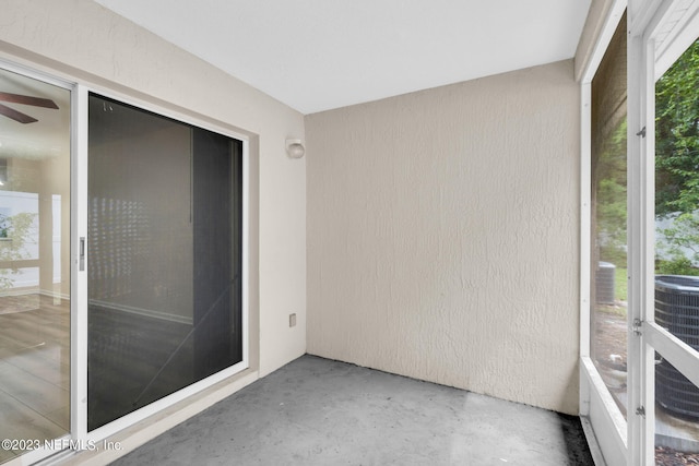 unfurnished sunroom featuring ceiling fan