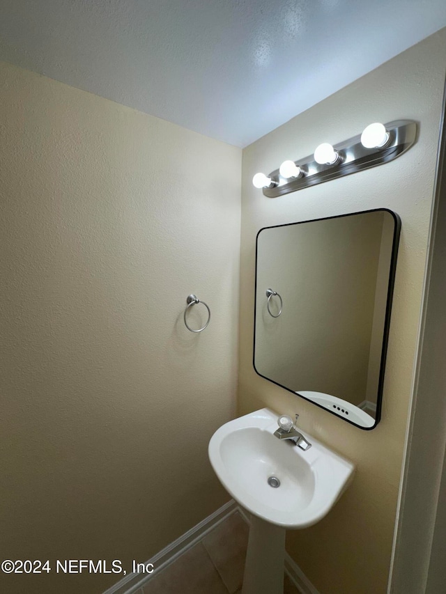 bathroom with tile patterned floors