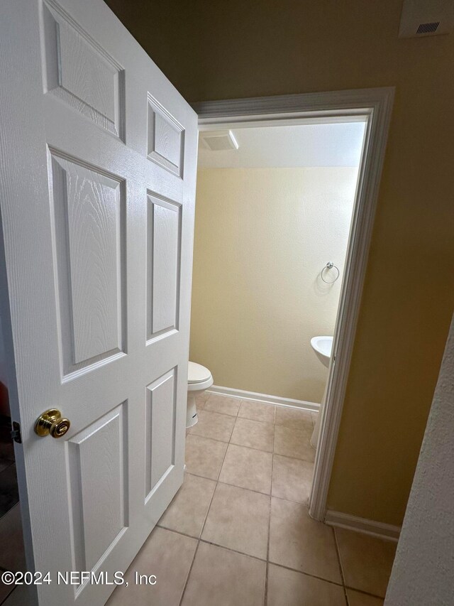 bathroom featuring tile patterned floors and toilet