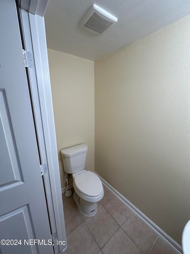 bathroom with tile patterned flooring and toilet