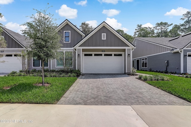 craftsman-style house featuring a garage and a front yard