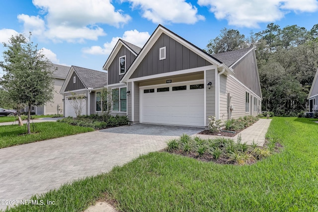 view of front of house featuring a garage and a front lawn