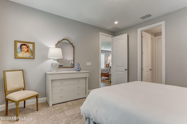 bedroom featuring light colored carpet