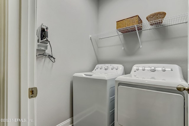 washroom featuring washer and clothes dryer