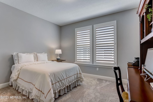 carpeted bedroom with a textured ceiling