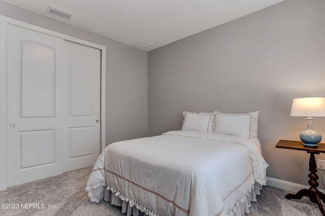 bedroom with carpet and a closet