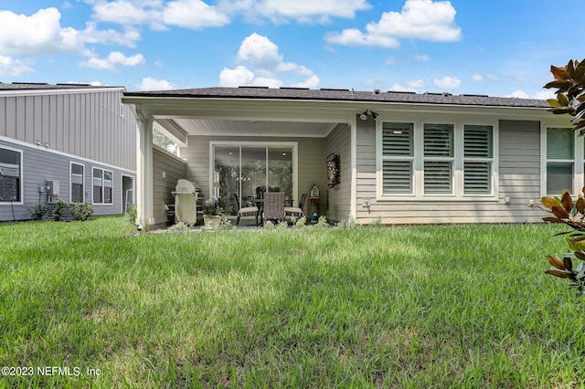 rear view of house with a lawn