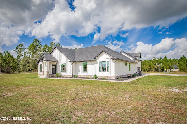 modern inspired farmhouse with a front lawn