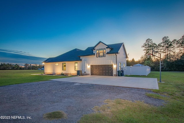 modern farmhouse style home with a garage and a yard