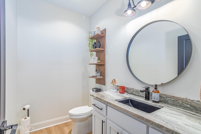 bathroom featuring hardwood / wood-style floors, vanity, and toilet