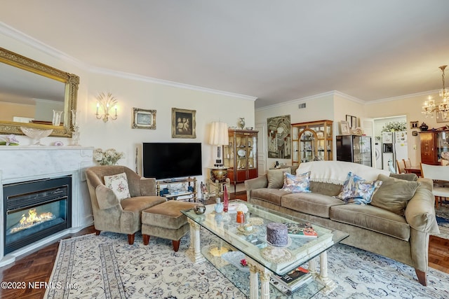 living room with a chandelier, parquet floors, and ornamental molding