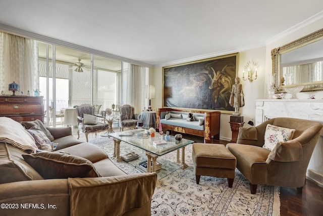 living area with ceiling fan, ornamental molding, and parquet flooring