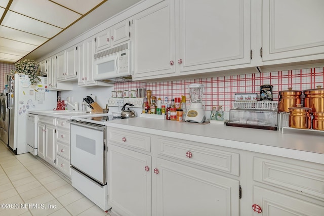 kitchen with decorative backsplash, white cabinetry, light tile patterned flooring, and white appliances