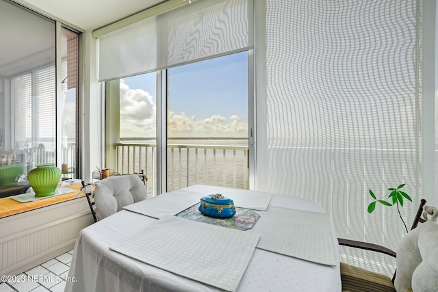 sunroom / solarium featuring a water view