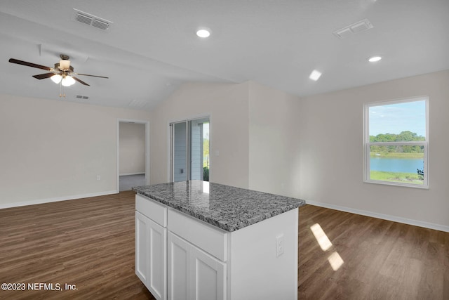 kitchen featuring dark stone counters, white cabinetry, ceiling fan, dark hardwood / wood-style floors, and lofted ceiling