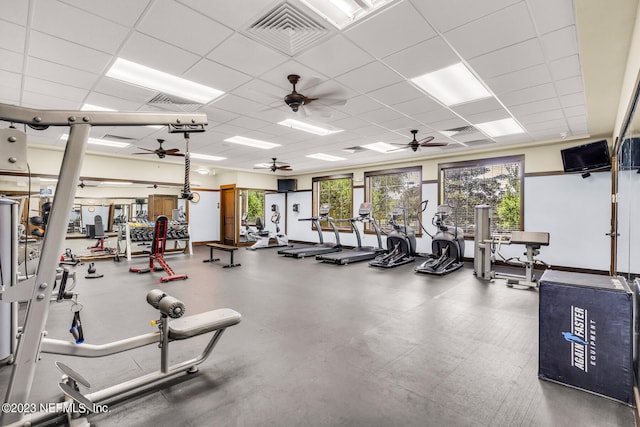 gym featuring ceiling fan and a drop ceiling