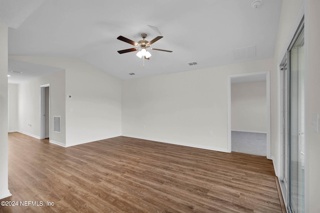 empty room featuring lofted ceiling, ceiling fan, and hardwood / wood-style floors