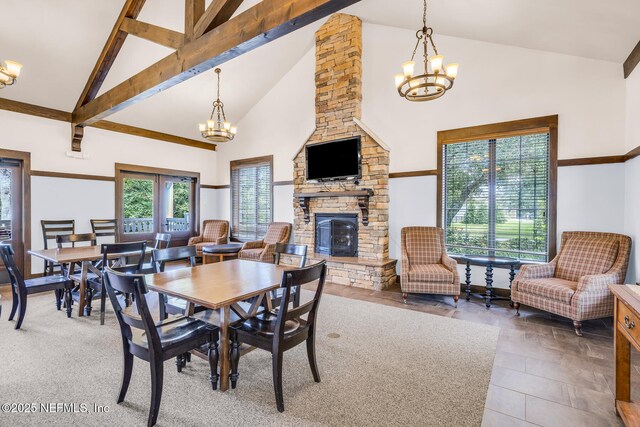 3176 Lowgap Pl, Green Cove Springs, FL 32043 - dining space with a chandelier, high vaulted ceiling, a fireplace, and beam ceiling