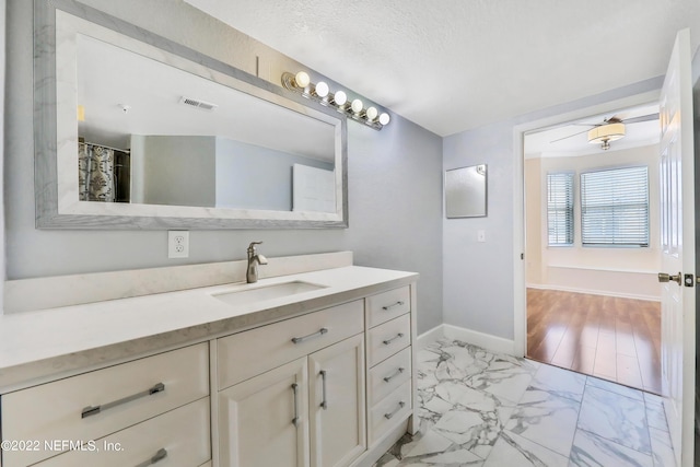 bathroom featuring vanity and a textured ceiling