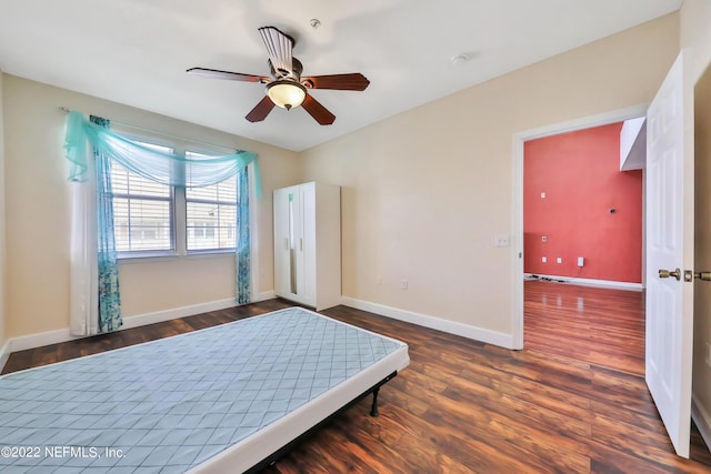 bedroom featuring ceiling fan and dark hardwood / wood-style flooring