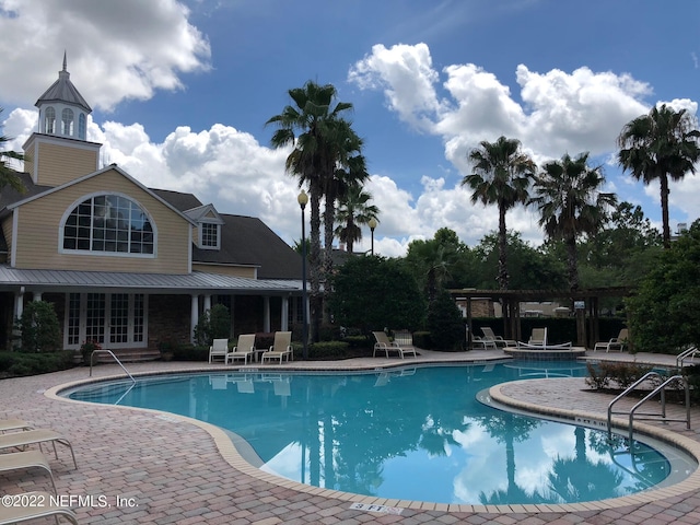 view of pool with a pergola and a patio