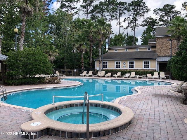 view of pool with a community hot tub and a patio area